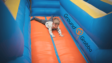 Safe summer fun with GroundGrabba ground anchors holding your bouncy house firm.