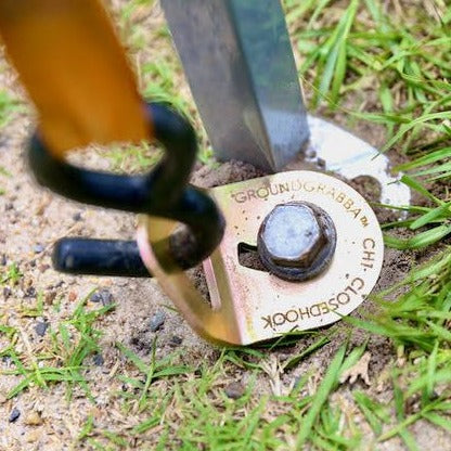 A ClosedHook holding in a GroundGrabba ground anchor. 